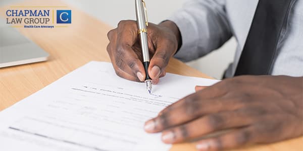 Image of a doctor signing a health care employment contract.
