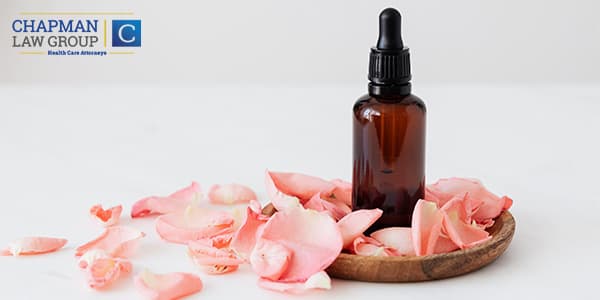 Image of a bottle of CBD oil and flower petals.