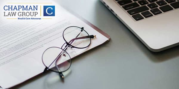 Notes and Glasses Near a Laptop Computer