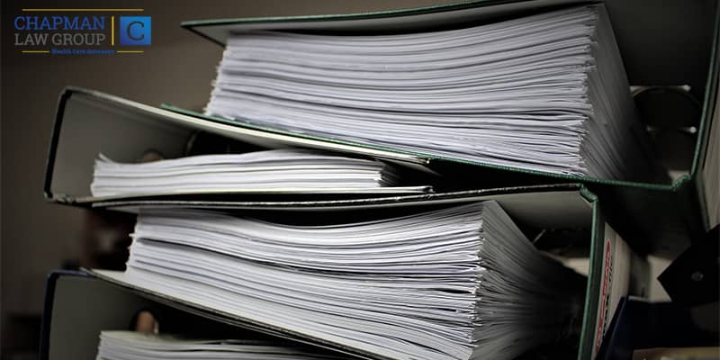 Large Ring Binders of medicaid audit defense laws that Chapman Law Group health care fraud defense attorneys reference.