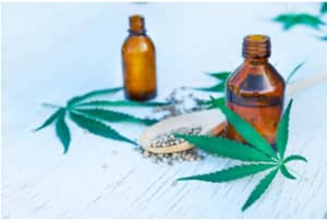 Image of marijuana leaves and CBD oil.