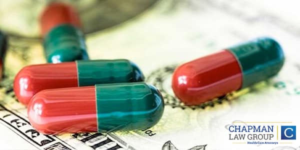 Image of pills on top of money.