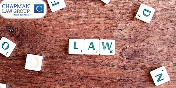Image of pieces from the board game "scrabble" that spell out the word "law".