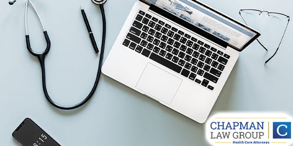Image of a stethescope, laptop, glasses, pen, and a smartphone.