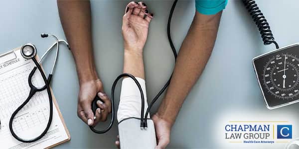 A doctor checking the blood pressure of a patient.