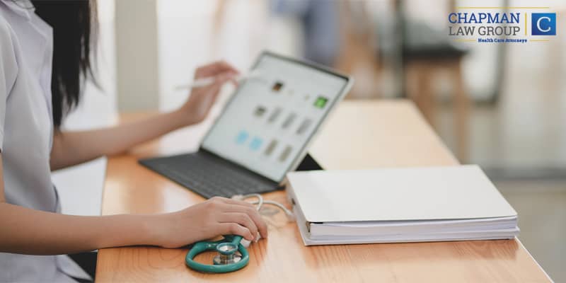 Doctor Reviewing Information on a Laptop Computer