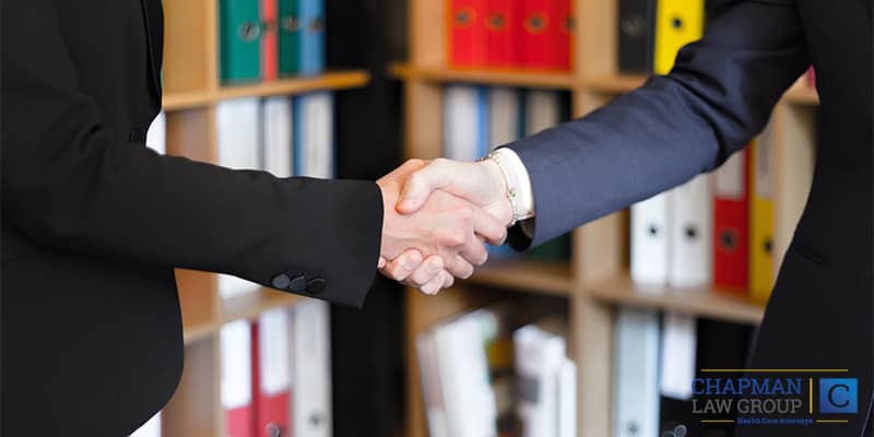 Healthcare Professional and Healthcare Lawyer Shaking Hands