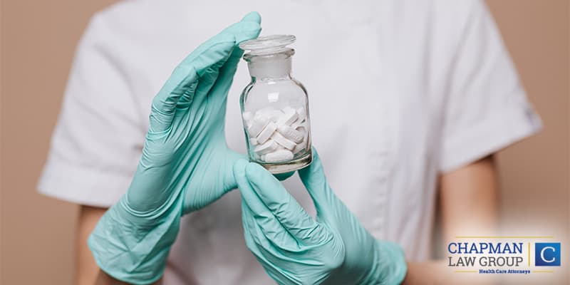 Image of a pharmacist holding a bottle of prescription opioid pills.