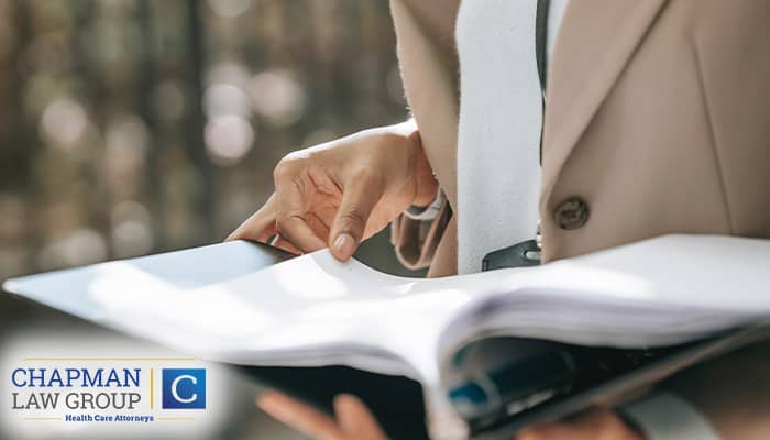 A health care defense attorney reviewing their legal defense before a court hearing.
